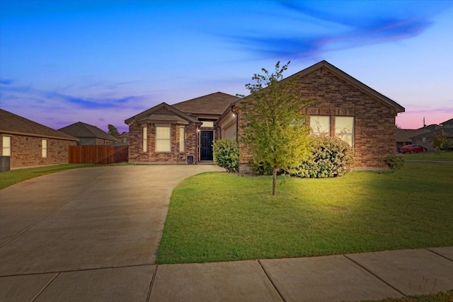 ranch-style home with a yard