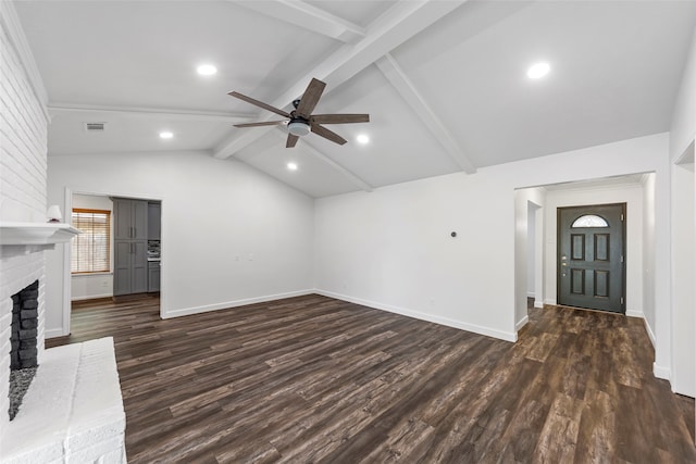 unfurnished living room with vaulted ceiling with beams, ceiling fan, dark hardwood / wood-style flooring, and a brick fireplace