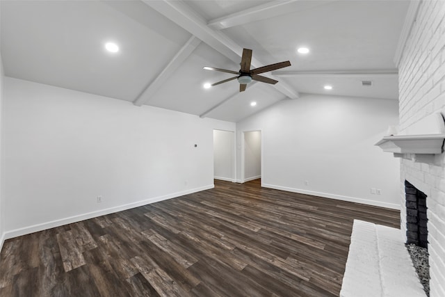 unfurnished living room featuring lofted ceiling with beams, dark hardwood / wood-style floors, ceiling fan, and a brick fireplace