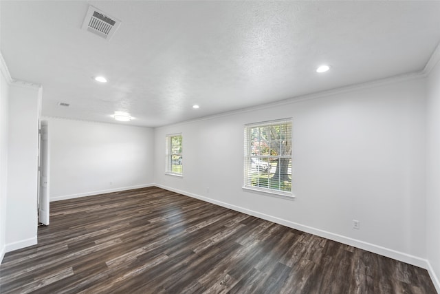 unfurnished room with a textured ceiling, dark hardwood / wood-style floors, and crown molding