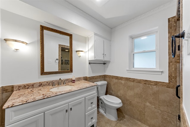 bathroom with vanity, toilet, a shower with door, and crown molding