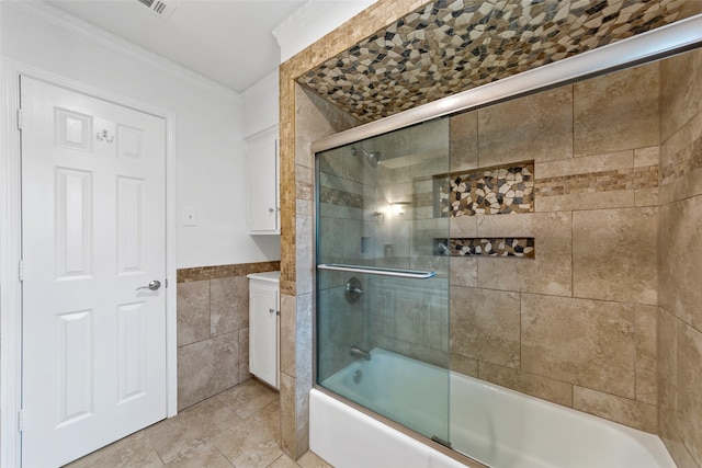 bathroom featuring tile patterned flooring, enclosed tub / shower combo, ornamental molding, and tile walls