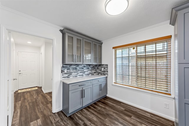 kitchen with dark hardwood / wood-style floors, gray cabinets, and crown molding