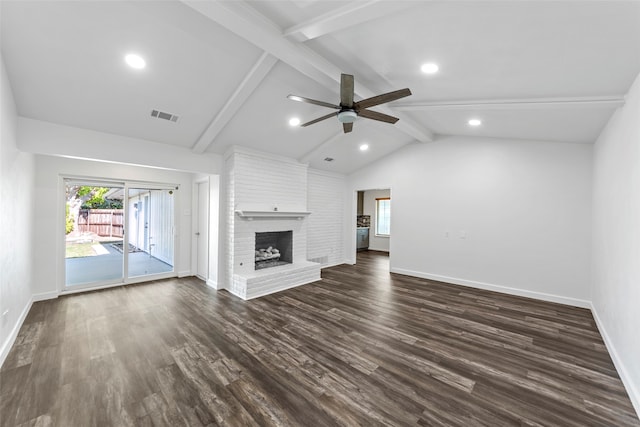 unfurnished living room with vaulted ceiling with beams, dark hardwood / wood-style floors, a brick fireplace, and ceiling fan