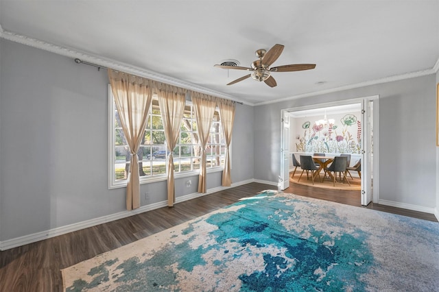 7101 Ellis Rd, Fort Worth, TX 76112 - empty room featuring ceiling fan, wood finished floors, ornamental molding, baseboards, and a chandelier