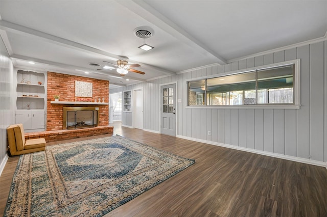 7101 Ellis Rd, Fort Worth, TX 76112 - living area with beamed ceiling, wood finished floors, ceiling fan, baseboards, and a fireplace