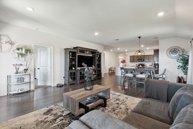 living room featuring dark hardwood / wood-style floors and lofted ceiling