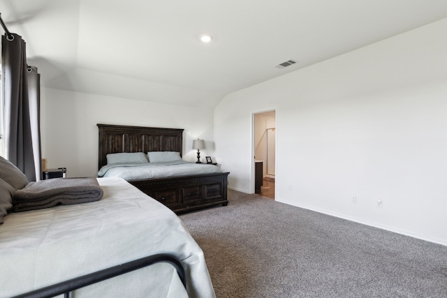 bedroom with dark carpet and lofted ceiling