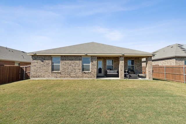 rear view of property with a patio and a lawn