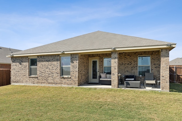 rear view of property with a lawn, outdoor lounge area, and a patio area