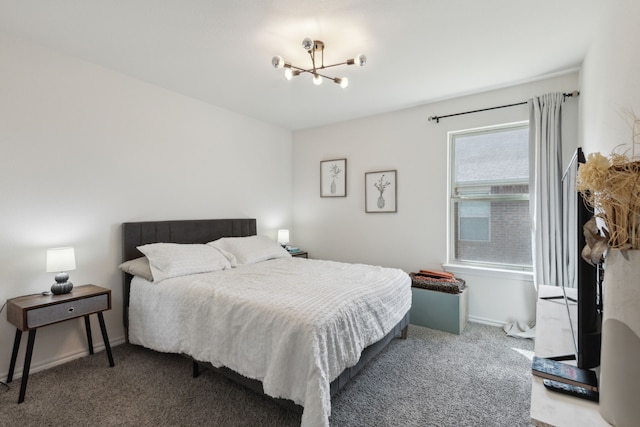 carpeted bedroom featuring a notable chandelier