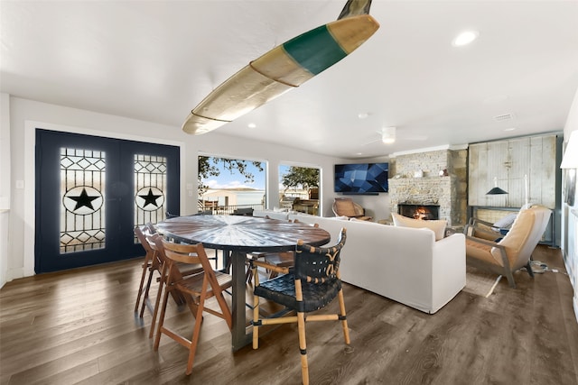 dining area featuring dark hardwood / wood-style floors and a fireplace