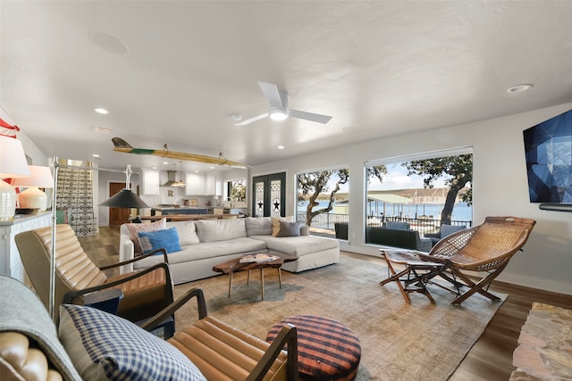 living room with ceiling fan and light wood-type flooring