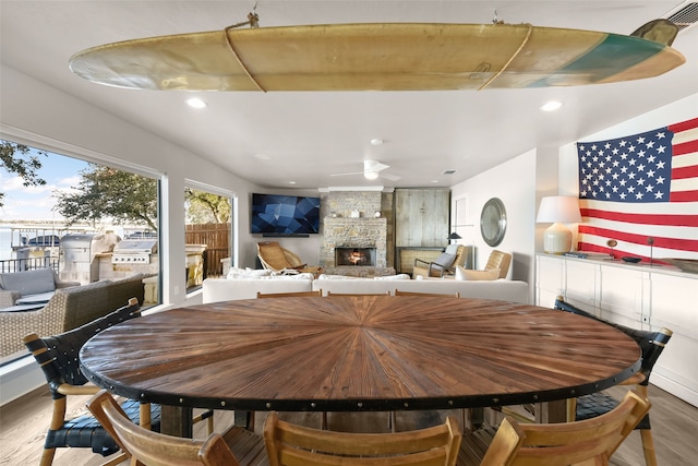 dining room featuring a fireplace and hardwood / wood-style flooring