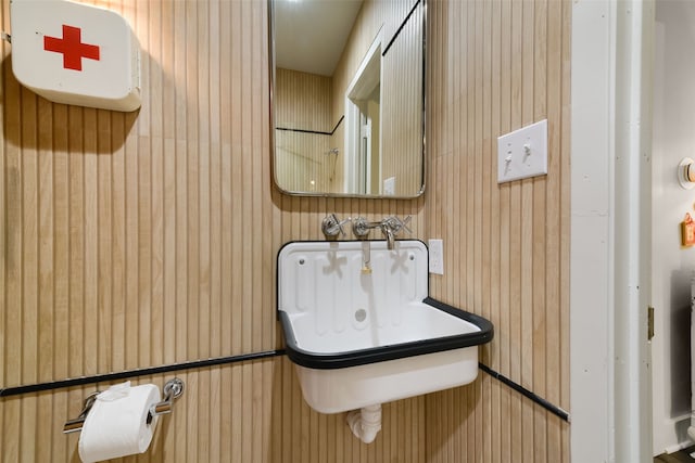 bathroom with wood walls