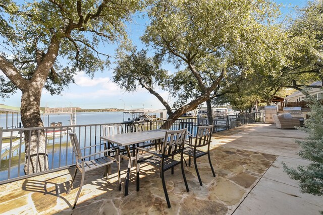 view of patio featuring a boat dock and a water view