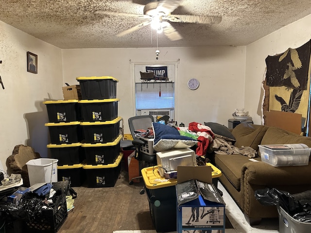 bedroom with ceiling fan, cooling unit, wood-type flooring, and a textured ceiling