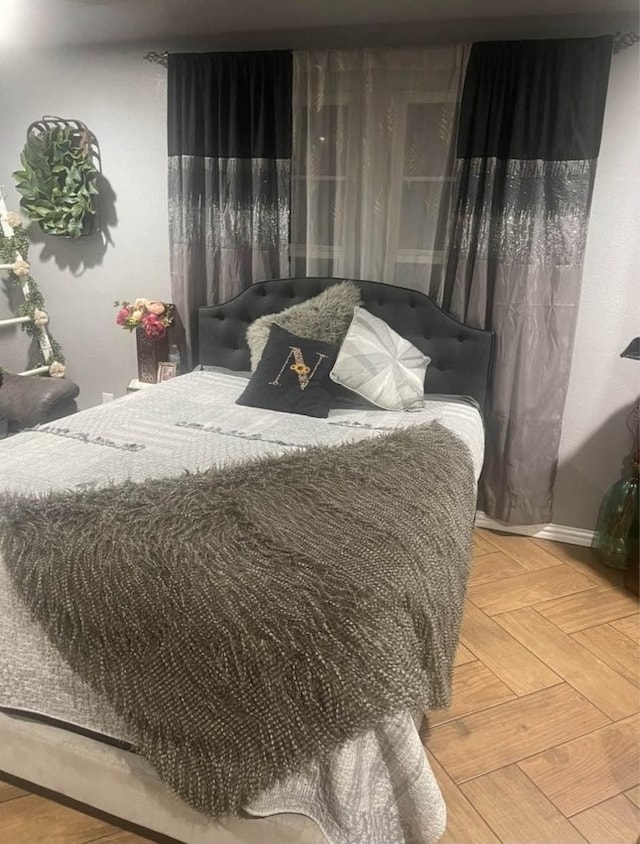 bedroom featuring parquet flooring