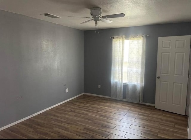 spare room with ceiling fan and hardwood / wood-style floors