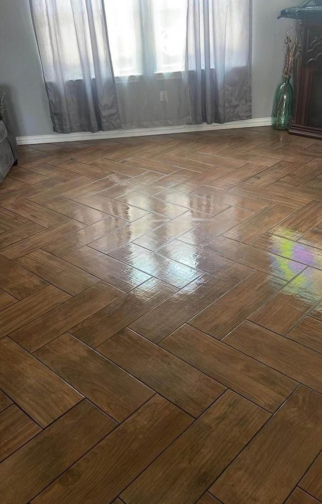 unfurnished room with parquet flooring