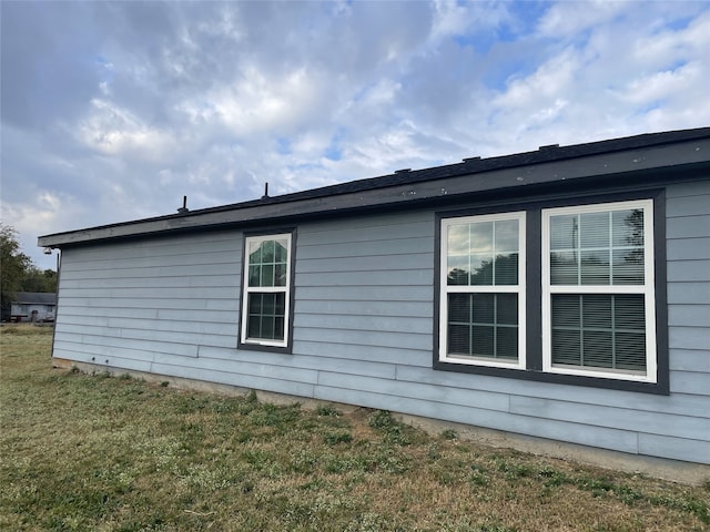 view of property exterior with a lawn