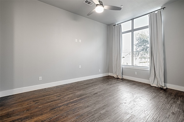 unfurnished room with dark hardwood / wood-style floors and ceiling fan