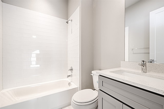 full bathroom with vanity, tiled shower / bath combo, and toilet