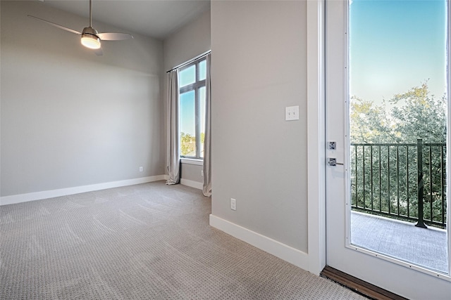 doorway to outside featuring light colored carpet and ceiling fan