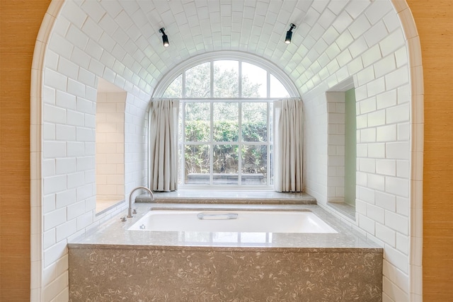 bathroom with tiled tub