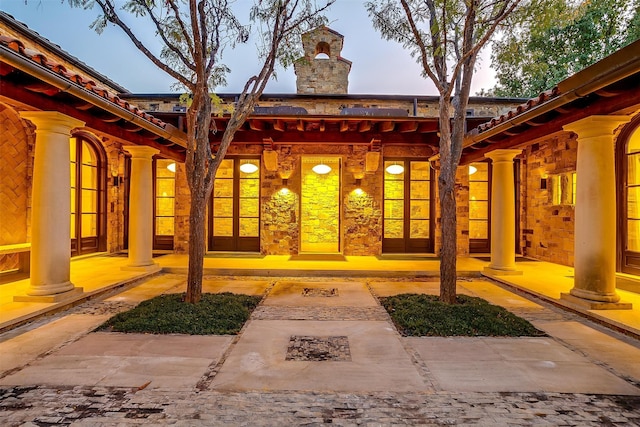 exterior entry at dusk with a patio