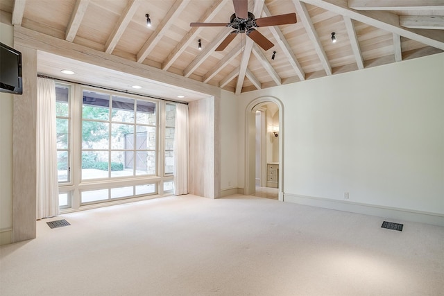 unfurnished room with beamed ceiling, ceiling fan, carpet floors, and high vaulted ceiling