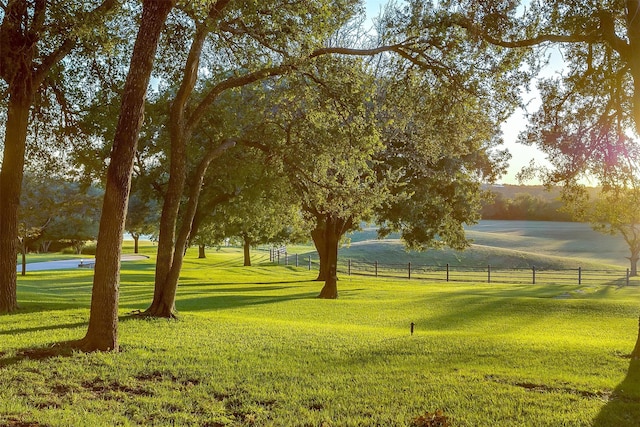 view of property's community featuring a lawn and a rural view