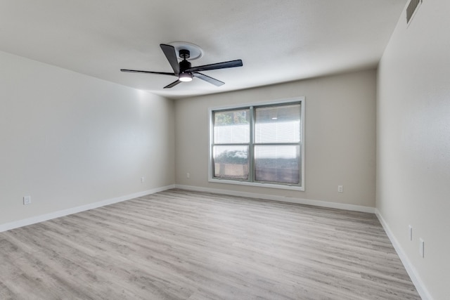 empty room with ceiling fan and light hardwood / wood-style floors