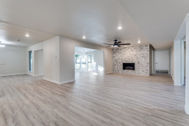 unfurnished living room with a fireplace, light hardwood / wood-style flooring, and ceiling fan