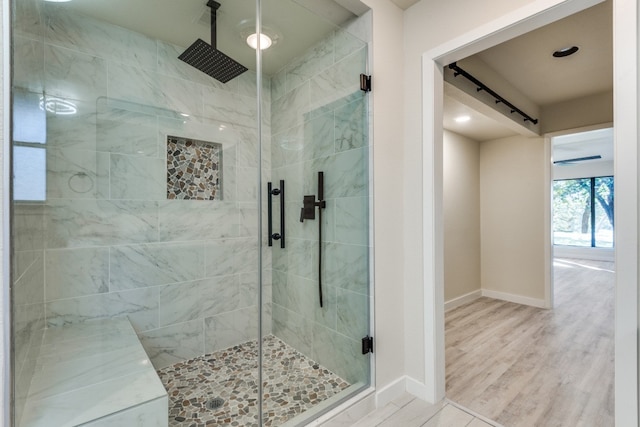 bathroom featuring hardwood / wood-style floors and a shower with shower door