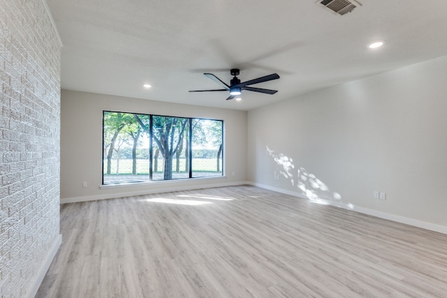 empty room featuring ceiling fan and light wood-type flooring