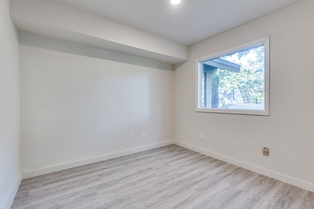 spare room with light hardwood / wood-style flooring