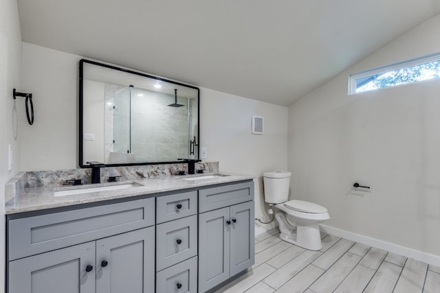 bathroom with hardwood / wood-style floors, vanity, an enclosed shower, and toilet