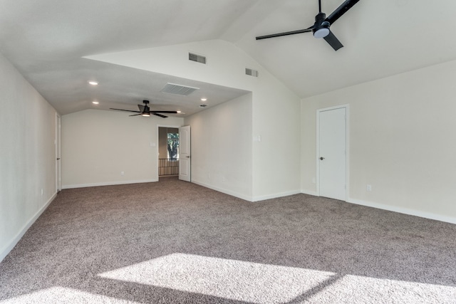 carpeted spare room featuring ceiling fan and vaulted ceiling