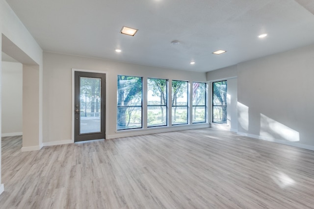 spare room featuring light hardwood / wood-style flooring