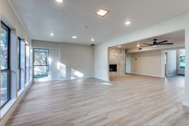 unfurnished living room featuring ceiling fan, plenty of natural light, and light hardwood / wood-style flooring