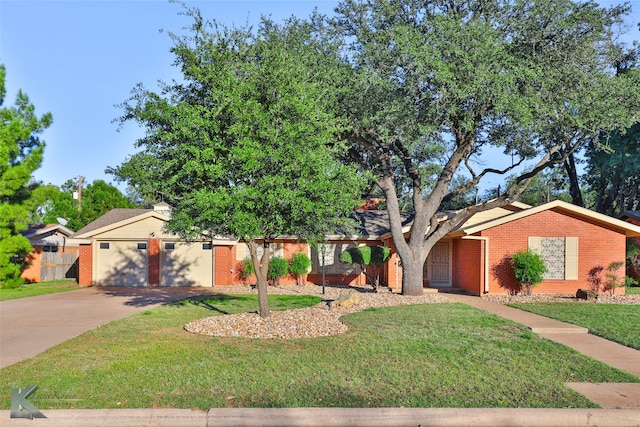 view of front of house with a garage and a front lawn