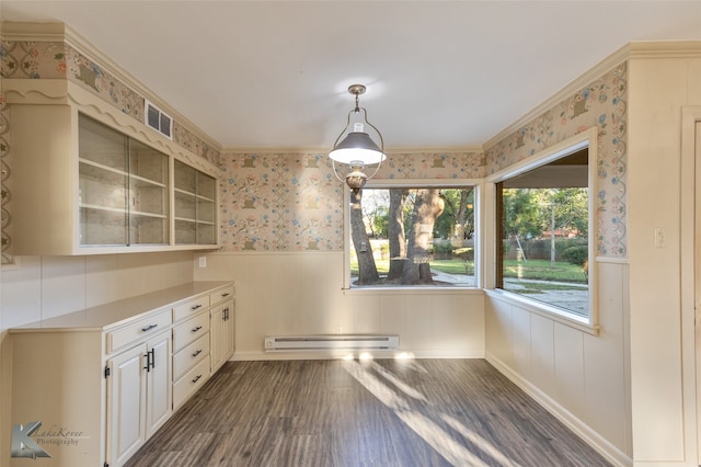 unfurnished dining area featuring baseboard heating, crown molding, and dark hardwood / wood-style floors