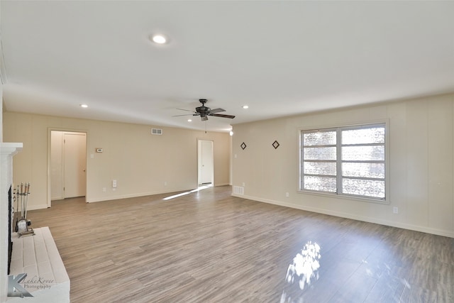 unfurnished living room featuring light wood-type flooring and ceiling fan