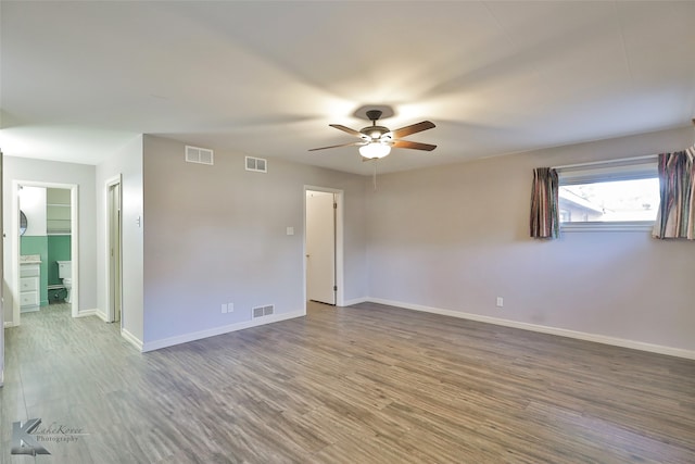 unfurnished room with ceiling fan and wood-type flooring