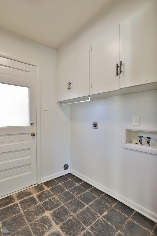 washroom with hookup for an electric dryer, cabinets, and hookup for a washing machine