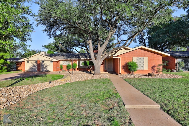 ranch-style home featuring a garage and a front yard