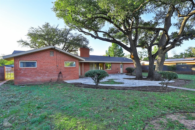 back of house featuring a lawn