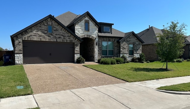 view of front of property featuring a front yard and a garage