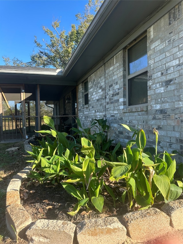 view of side of home with a sunroom